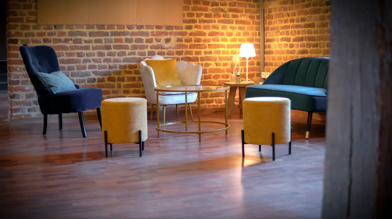 L’espace lounge : fauteuils, poufs jaunes et parquet.